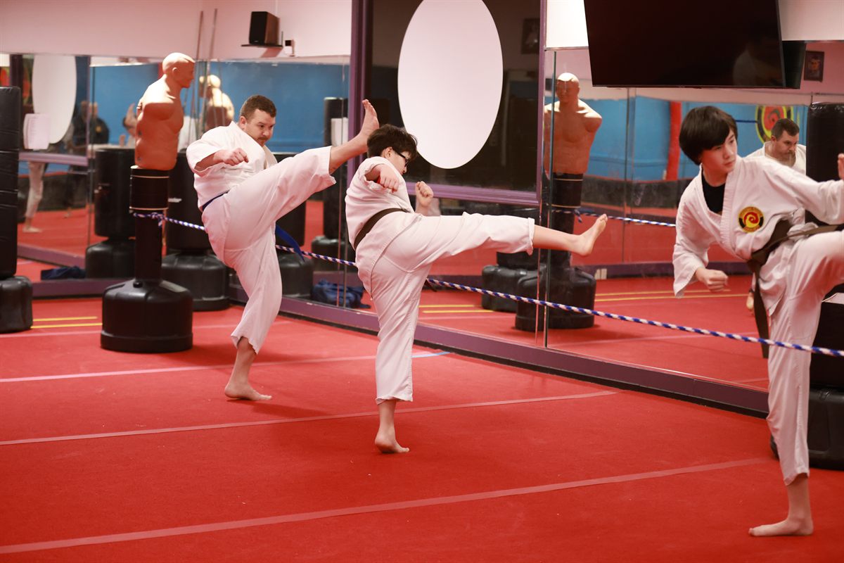 Karate students practicing synchronized kicks