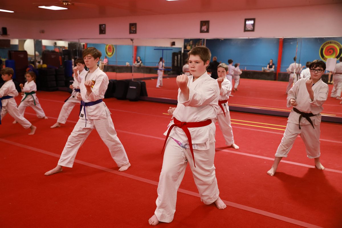 Youth karate class training in formation