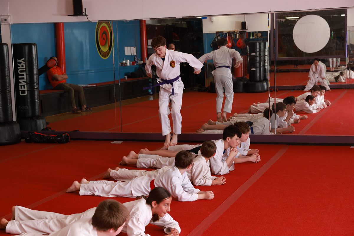 Kids karate class practicing on the mat