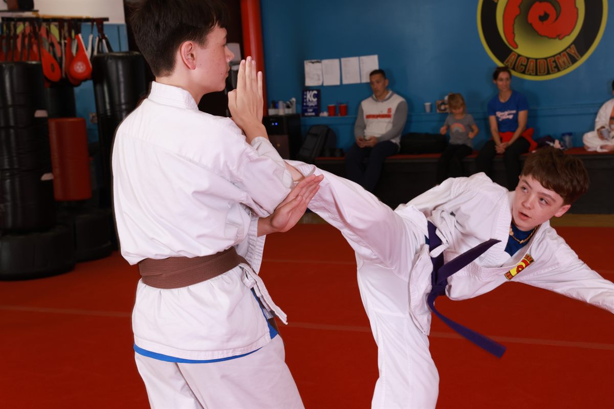 Karate student practicing a high kick